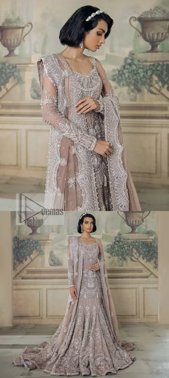 Luxurious canvas embodying grace and style! It is a well-crafted short shirt enhanced with silver embroidery accentuated with gleaming ornaments. The following shirt is incrusted with tilla, dabka, kora, zardozi and beautiful detailing of crystal. Further, it is coordinated with a back train lehenga which is meticulously adorned with heavy embroidery to make you the real dreamy fairy. Complete this Walima article with a dupatta in the same colour, framed with a four-sided border. The tiny floral motifs and sequins sprayed spread all over on the dupatta for memorable grace.