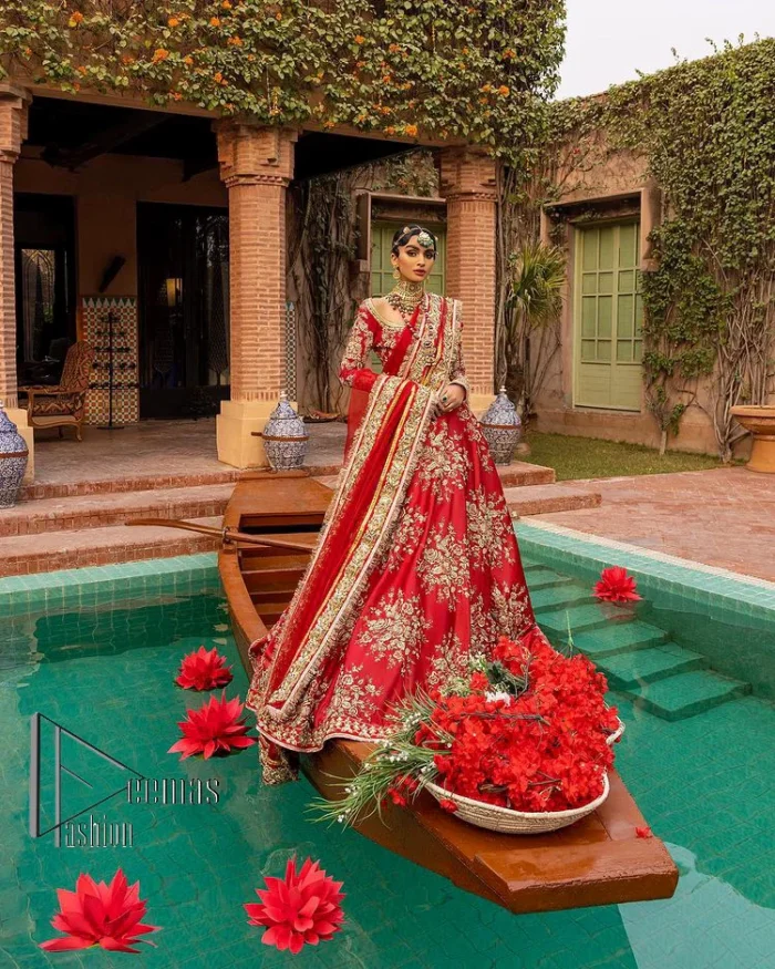 Nothing beats the luxury of bright red couture in reception. Our luxury bright red blouse is entirely hand-worked and finished with the fine material of golden embroidery which is self-explanatory of the uniqueness of the attire. It is further enhanced with tilla, dabka, kora and Sitara. The boat shape neckline also added engaging and attractive beauty to the outfit when comes to full sleeves. It is organized with flared lehenga to make your day super amazing and fulfil your dreamy romantic look. Complete this with a dupatta which is embellished with four-sided borders and sequins sprayed all over to beat the luxury of bright red.