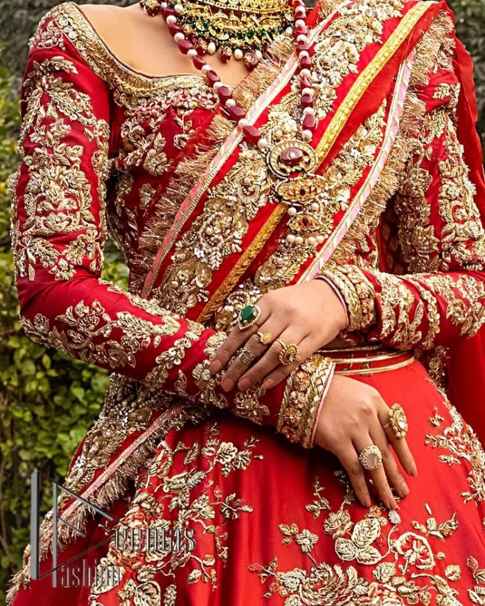 Nothing beats the luxury of bright red couture in reception. Our luxury bright red blouse is entirely hand-worked and finished with the fine material of golden embroidery which is self-explanatory of the uniqueness of the attire. It is further enhanced with tilla, dabka, kora and Sitara. The boat shape neckline also added engaging and attractive beauty to the outfit when comes to full sleeves. It is organized with flared lehenga to make your day super amazing and fulfil your dreamy romantic look. Complete this with a dupatta which is embellished with four-sided borders and sequins sprayed all over to beat the luxury of bright red.