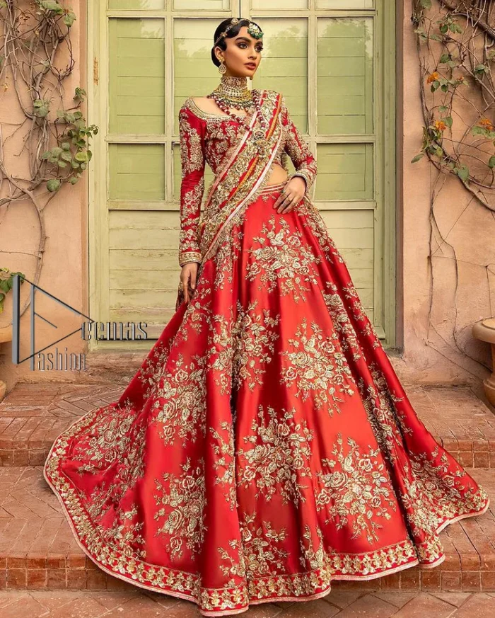 Nothing beats the luxury of bright red couture in reception. Our luxury bright red blouse is entirely hand-worked and finished with the fine material of golden embroidery which is self-explanatory of the uniqueness of the attire. It is further enhanced with tilla, dabka, kora and Sitara. The boat shape neckline also added engaging and attractive beauty to the outfit when comes to full sleeves. It is organized with flared lehenga to make your day super amazing and fulfil your dreamy romantic look. Complete this with a dupatta which is embellished with four-sided borders and sequins sprayed all over to beat the luxury of bright red.