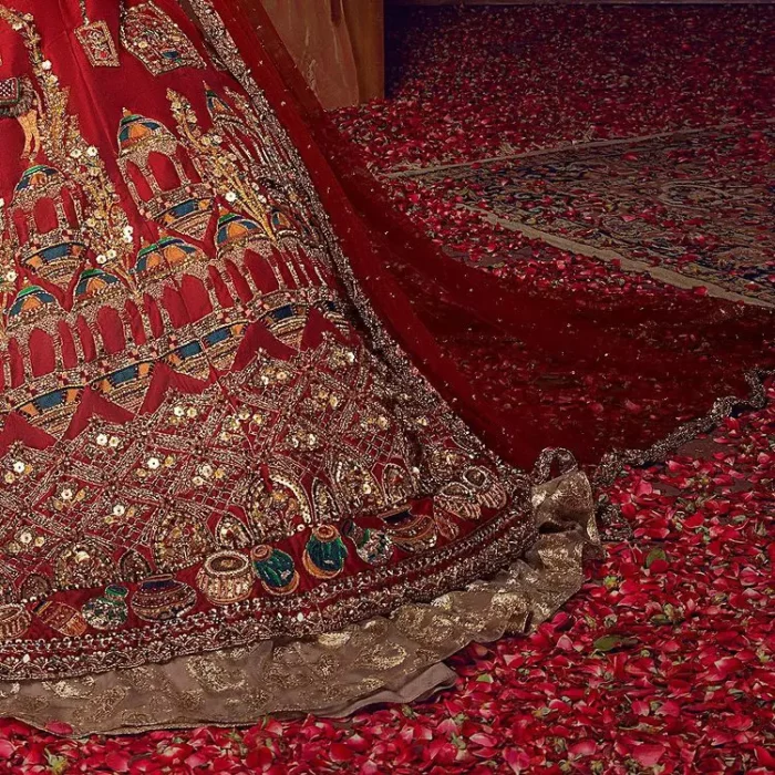 Stun in this classic canvas with crimson maroon adornment at your reception. DeemasFashion presents this outfit which begins with a maxi that is luxuriously encrusted with tilla, dabka, Resham, Sitara and specific shorts of zardozi. Scintillating with detailed embroidery in multiple-colour to make you the fashion start of the era. The round neckline of the maxi along with the three-quarter sleeves makes the traditional look. It is systemized with lehenga made with pure jamawar in ivory colour. Complete this article with a dupatta, framed with a four-sided border and sequins sprayed all over to fulfilling the promising stunning bride look.
