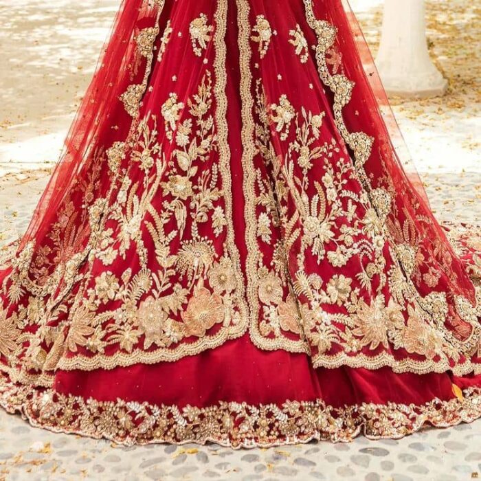 Vibrant outfit to make your reception day more shiny and bright. DeemasFashion presents this maxi in deep red colour, featuring golden embroidery which is enhanced with tilla, dabka, kora, naqshi, zardozi and the magic of Resham. The following scalloped front open maxi has a Round neckline to meet the traditional look when comes with three-quarter sleeves.  In addition to this, it is paired up with a back train lehenga in the same colour framed with embroidery on the border. Complete this article with a scalloped dupatta which is adorned with four-sided borders and sequins sprayed all over for sun-kissed splendour!