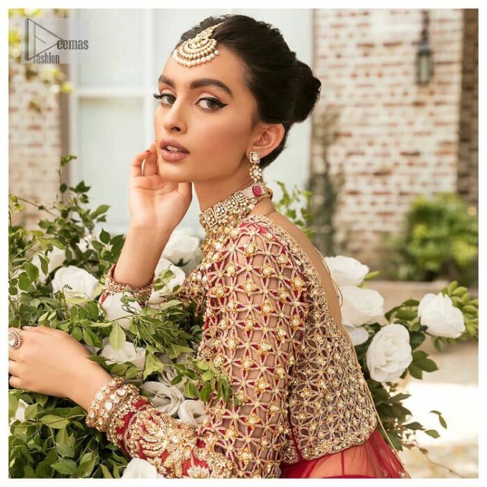 Vibrant outfit to make your reception day more shiny and bright. DeemasFashion presents this maxi in deep red colour, featuring golden embroidery which is enhanced with tilla, dabka, kora, naqshi, zardozi and the magic of Resham. The following scalloped front open maxi has a Round neckline to meet the traditional look when comes with three-quarter sleeves.  In addition to this, it is paired up with a back train lehenga in the same colour framed with embroidery on the border. Complete this article with a scalloped dupatta which is adorned with four-sided borders and sequins sprayed all over for sun-kissed splendour!