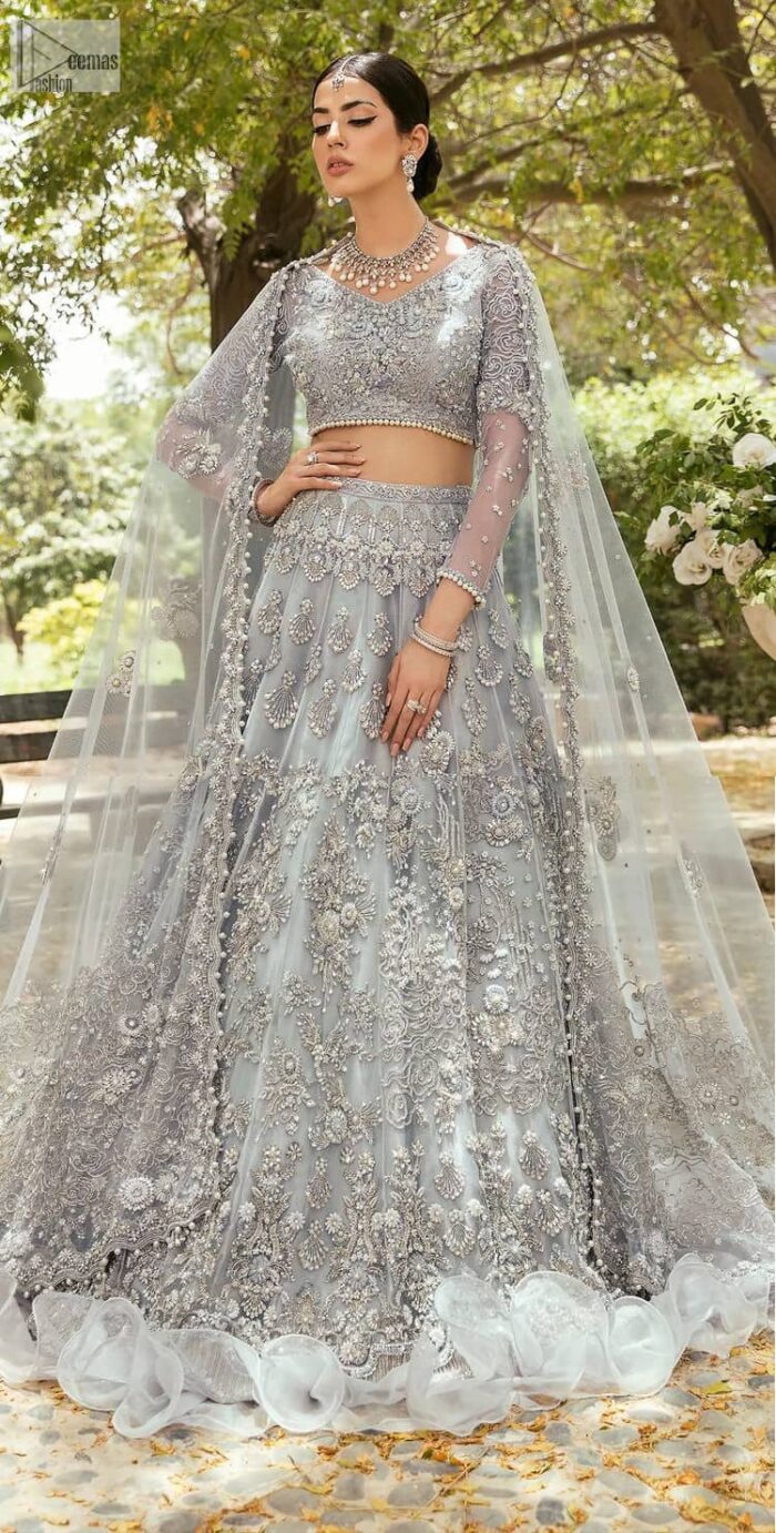 The magic of luxurious romantic outfits, giving you love at your Walima. The outfit defines the endless beauty of the immaculately produced pieces with intricate silver and golden embellishments, which are further magnified wth tilla, dabka, kora, Kundan and crystal. The full sleeve style of the blouse along with V shape neckline just gives you a unique way of artistic look. It is systemized with frilled lehenga which is heavily embellished with floral patterns to make your day more charming and delightful. Complete this article with a dupatta which is embellished with a four-sided border and ting floral motifs all over that are a dream of someone's special moment.