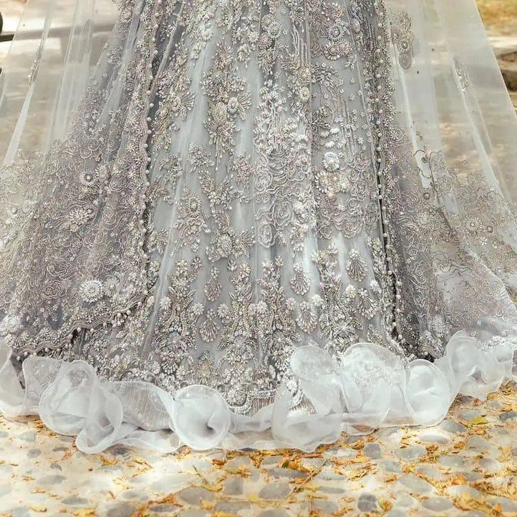 The magic of luxurious romantic outfits, giving you love at your Walima. The outfit defines the endless beauty of the immaculately produced pieces with intricate silver and golden embellishments, which are further magnified wth tilla, dabka, kora, Kundan and crystal. The full sleeve style of the blouse along with V shape neckline just gives you a unique way of artistic look. It is systemized with frilled lehenga which is heavily embellished with floral patterns to make your day more charming and delightful. Complete this article with a dupatta which is embellished with a four-sided border and ting floral motifs all over that are a dream of someone's special moment.