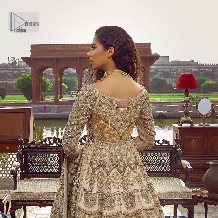 Capturing the essence of modernity on your Nikah with this ivory article. DeemasFashion presents this frock which is intricate with hand embroidery that includes tilla, dabka, kora, Kundan, zardozi and magic of crystal. It is intensified with silver and gold embroidery to make your Qabool Hai moment more delightful and pleasant. Further, the boat shape neckline with three-quarter sleeves strengthens the beauty of the outfit. The following frock is systemized with a lehenga whose border is framed with heavy embroidery. The floral motifs also spread on the lehenga. Complete this outfit with a dupatta in the same colour which is ornamented with four-sided borders and sequins sprayed all over to capture the modern bride.