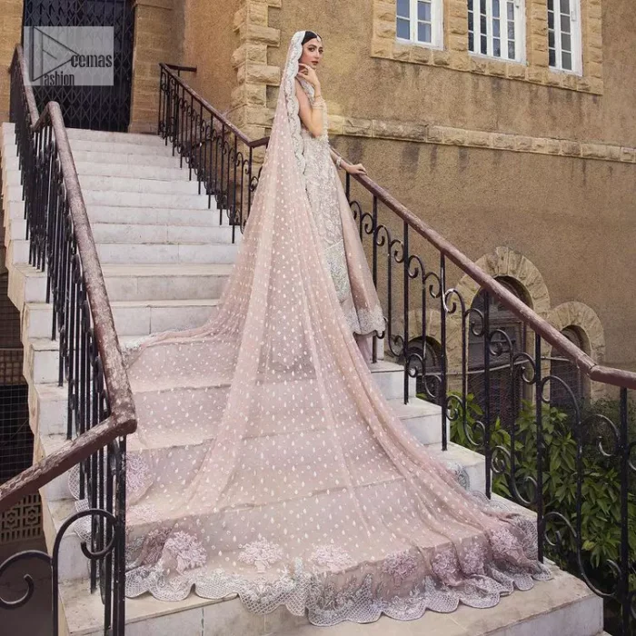 The subtle colour palette, delicate embroidery and eye-catching details. All in all a true style statement! Presenting this light brown maxi which is a luxuriously encrusted masterpiece is laden with tilla, dabka kora, stones,  and delicate Resham. The following front open scalloped maxi is adorned with silver embroidery to make your Nikah day remarkable. The embellished neckline along with the sleeveless style makes you a pretty and unique bride ever. Paired up this article with a sharara whose border is adorned with embroidery. Finish this outfit with a dupatta, framed with four-sided borders and sequins sprayed all over for attractiveness and marvellous details.