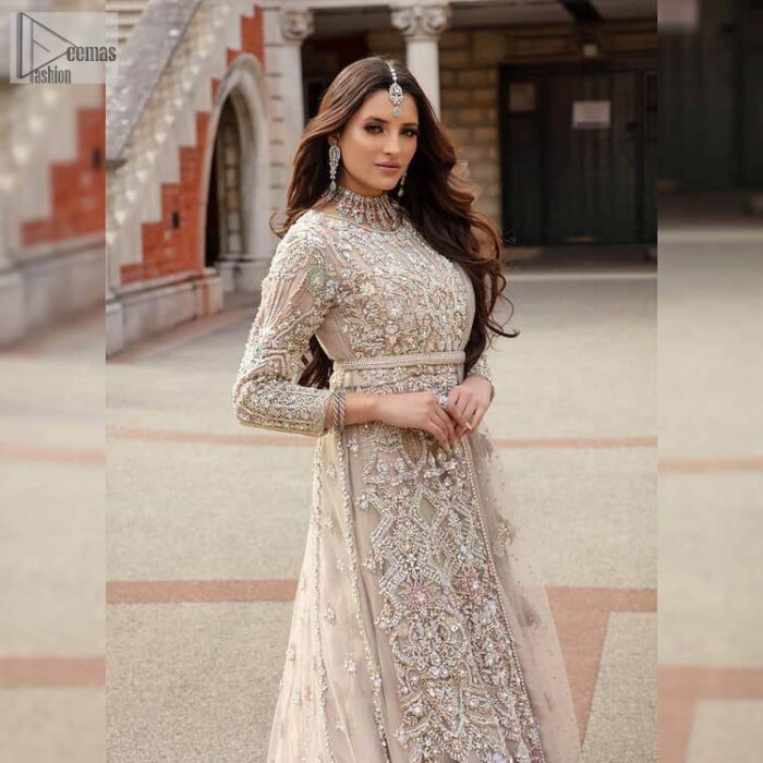 Filling the air with utmost happiness, joy ad fun for your Walima day. A handsome and attractive light fawn maxi laboriously roasted with meticulously detailed multiple colour hand embellishment which is further blooms with tilla, dabka, kora, naqshi and magic of Sitara. The jewel neckline of the following front open back train maxi looks so aesthetic when organized with three-quarter sleeves. It is paired up with lehenga in the same colour which is adorned with floral motifs and sequins spray spread all over to make your event more remarkable and shiny. Finish this article with the dupatta which is framed with magical four-sided borders and sequins sprayed all over to fulfil the dreamy fairy look.