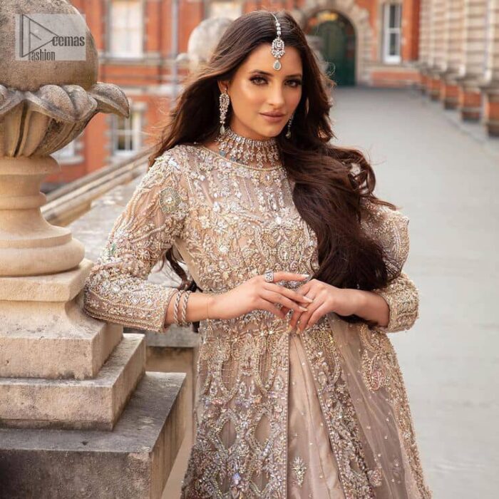 Filling the air with utmost happiness, joy ad fun for your Walima day. A handsome and attractive light fawn maxi laboriously roasted with meticulously detailed multiple colour hand embellishment which is further blooms with tilla, dabka, kora, naqshi and magic of Sitara. The jewel neckline of the following front open back train maxi looks so aesthetic when organized with three-quarter sleeves. It is paired up with lehenga in the same colour which is adorned with floral motifs and sequins spray spread all over to make your event more remarkable and shiny. Finish this article with the dupatta which is framed with magical four-sided borders and sequins sprayed all over to fulfil the dreamy fairy look.