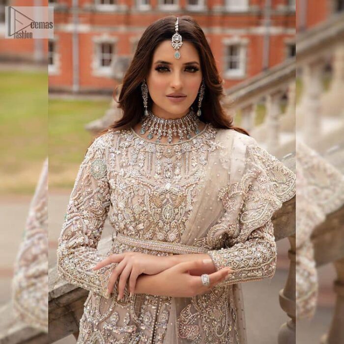 Filling the air with utmost happiness, joy ad fun for your Walima day. A handsome and attractive light fawn maxi laboriously roasted with meticulously detailed multiple colour hand embellishment which is further blooms with tilla, dabka, kora, naqshi and magic of Sitara. The jewel neckline of the following front open back train maxi looks so aesthetic when organized with three-quarter sleeves. It is paired up with lehenga in the same colour which is adorned with floral motifs and sequins spray spread all over to make your event more remarkable and shiny. Finish this article with the dupatta which is framed with magical four-sided borders and sequins sprayed all over to fulfil the dreamy fairy look.