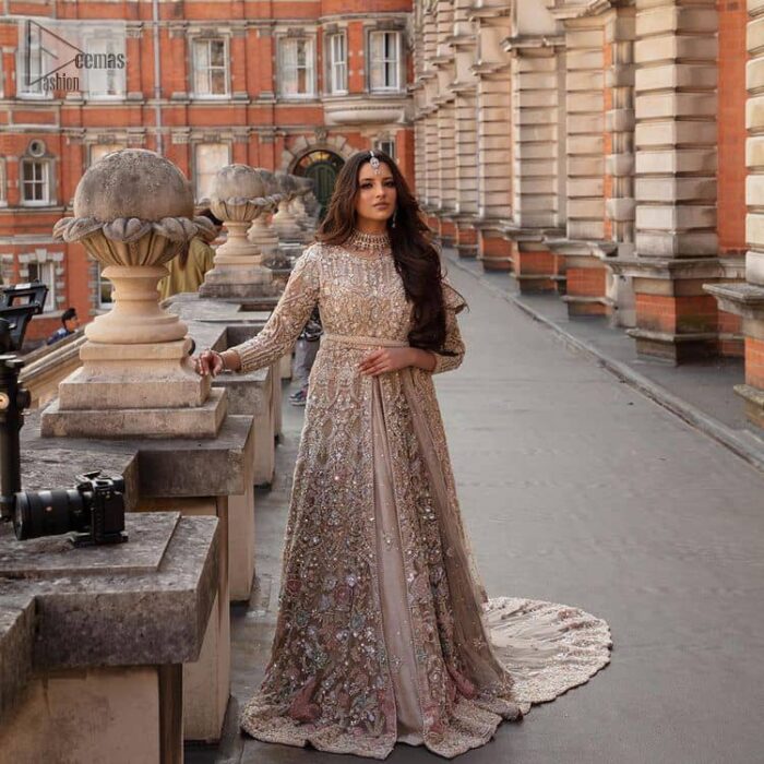 Filling the air with utmost happiness, joy ad fun for your Walima day. A handsome and attractive light fawn maxi laboriously roasted with meticulously detailed multiple colour hand embellishment which is further blooms with tilla, dabka, kora, naqshi and magic of Sitara. The jewel neckline of the following front open back train maxi looks so aesthetic when organized with three-quarter sleeves. It is paired up with lehenga in the same colour which is adorned with floral motifs and sequins spray spread all over to make your event more remarkable and shiny. Finish this article with the dupatta which is framed with magical four-sided borders and sequins sprayed all over to fulfil the dreamy fairy look.