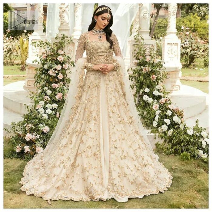 Mark your Nikah day in a calendar as a special one with this marvellous outfit. DeemasFashion presents this outfit in light fawn colour which begins with a back train scalloped maxi. The following maxi is sumptuously embellished with a golden embroidery which is further intensified with tilla, dabka, naqshi, Resham and zardozi. The sweetheart neckline of the maxi is heavily embellished and looks romantic when comes with full sleeves style. It is handsomely paired up with a lehenga in the same colour which is so plain to balance the look of the outfit. Finish this article with a scalloped dupatta which is embellished with four-sided borders and sequins sprayed all over to make your day more magical. 