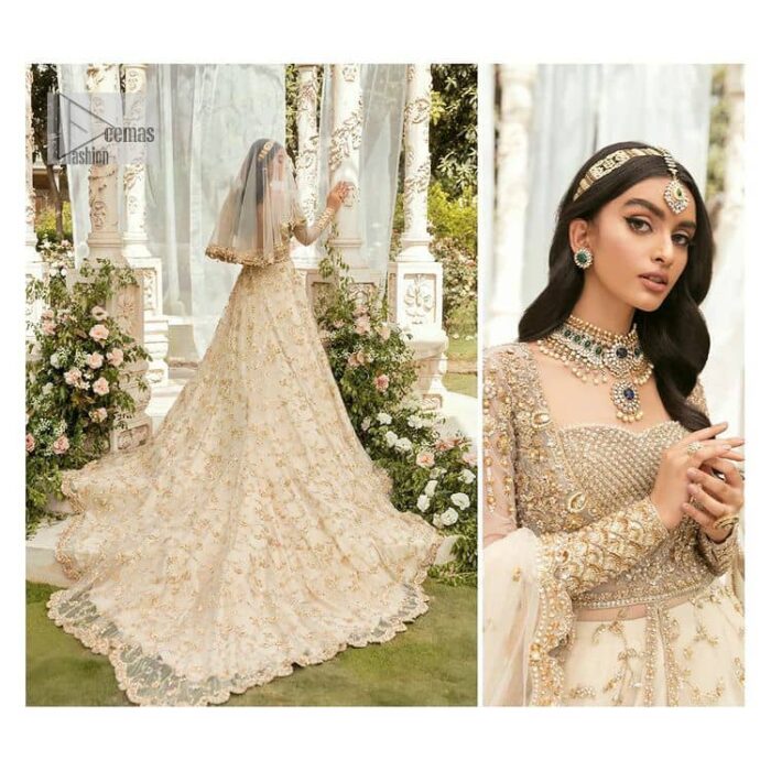 Mark your Nikah day in a calendar as a special one with this marvellous outfit. DeemasFashion presents this outfit in light fawn colour which begins with a back train scalloped maxi. The following maxi is sumptuously embellished with a golden embroidery which is further intensified with tilla, dabka, naqshi, Resham and zardozi. The sweetheart neckline of the maxi is heavily embellished and looks romantic when comes with full sleeves style. It is handsomely paired up with a lehenga in the same colour which is so plain to balance the look of the outfit. Finish this article with a scalloped dupatta which is embellished with four-sided borders and sequins sprayed all over to make your day more magical. 