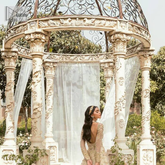 Mark your Nikah day in a calendar as a special one with this marvellous outfit. DeemasFashion presents this outfit in light fawn colour which begins with a back train scalloped maxi. The following maxi is sumptuously embellished with a golden embroidery which is further intensified with tilla, dabka, naqshi, Resham and zardozi. The sweetheart neckline of the maxi is heavily embellished and looks romantic when comes with full sleeves style. It is handsomely paired up with a lehenga in the same colour which is so plain to balance the look of the outfit. Finish this article with a scalloped dupatta which is embellished with four-sided borders and sequins sprayed all over to make your day more magical. 