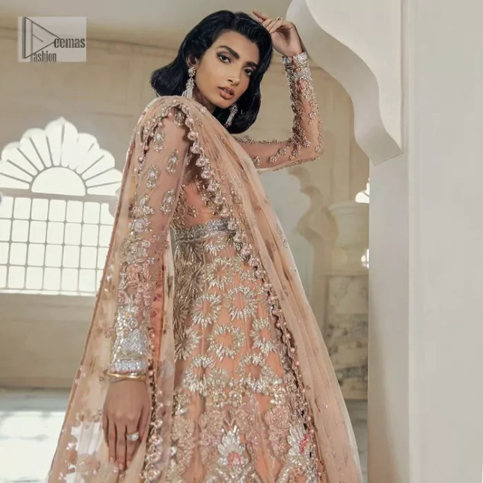 Be the happiest bride in your Walima as the orange colour is the most optimistic among all. The light orange front open maxi is complemented with delicate silver embroidery, further enhanced with the beautiful detailing which includes tilla, dabka, kora, Kundan and the real magic of crystal to make you the star of the show. The high neckline also looks like a unique masterpiece when it comes with full sleeves. It is organized with a flared lehenga that is also adorned with heavy embroidery. The flare of the following lehenga gives a dreamy fairy look to every bride. Complete this outfit with a scalloped dupatta in the same colour framed with four-sided borders and floral motifs all over to win the quote of the happiest bride.