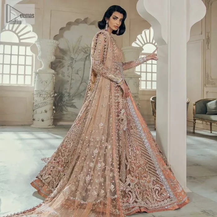 Be the happiest bride in your Walima as the orange colour is the most optimistic among all. The light orange front open maxi is complemented with delicate silver embroidery, further enhanced with the beautiful detailing which includes tilla, dabka, kora, Kundan and the real magic of crystal to make you the star of the show. The high neckline also looks like a unique masterpiece when it comes with full sleeves. It is organized with a flared lehenga that is also adorned with heavy embroidery. The flare of the following lehenga gives a dreamy fairy look to every bride. Complete this outfit with a scalloped dupatta in the same colour framed with four-sided borders and floral motifs all over to win the quote of the happiest bride.