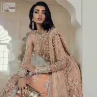 Be the happiest bride in your Walima as the orange colour is the most optimistic among all. The light orange front open maxi is complemented with delicate silver embroidery, further enhanced with the beautiful detailing which includes tilla, dabka, kora, Kundan and the real magic of crystal to make you the star of the show. The high neckline also looks like a unique masterpiece when it comes with full sleeves. It is organized with a flared lehenga that is also adorned with heavy embroidery. The flare of the following lehenga gives a dreamy fairy look to every bride. Complete this outfit with a scalloped dupatta in the same colour framed with four-sided borders and floral motifs all over to win the quote of the happiest bride.
