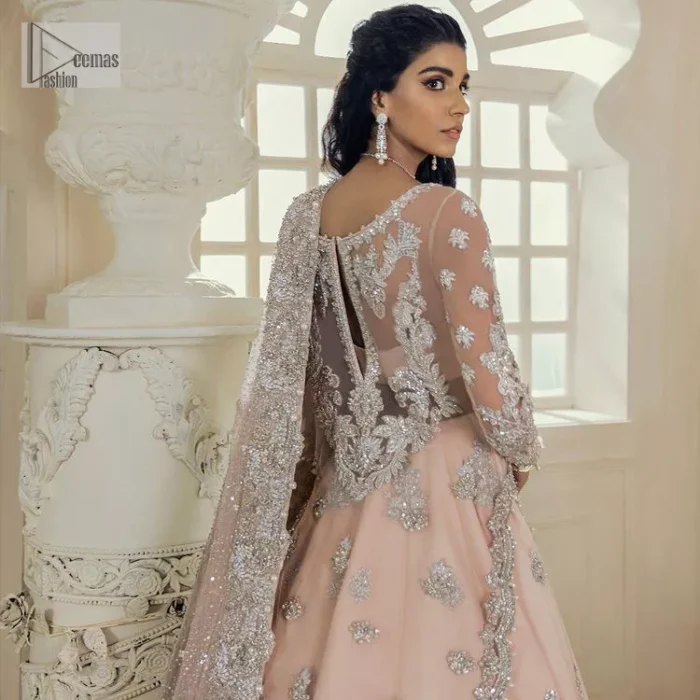 Get yourself a sweet treat, as this ensemble showcases the majestic light orange colour inscribed with lustrous embellishments. A combination of light orange attached grantly to the organza scalloped shirt heightened with silver embroidery. The shirt is intensified with tones of dabka, tilla, kora and blossoms of Resham coupled with a defined sweetheart neckline along with full sleeves. It is coordinated with a flared sharara which is embellished with floral motifs and ornamented borders. This outfit establishes a vibe of its own on your Walima day when finished with a dupatta which is framed with four-sided borders and sequins sprayed all over.
