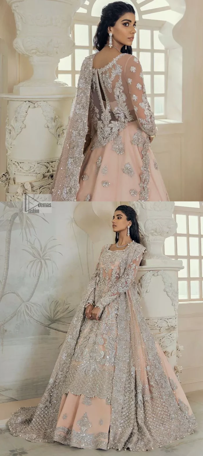 Get yourself a sweet treat, as this ensemble showcases the majestic light orange colour inscribed with lustrous embellishments. A combination of light orange attached grantly to the organza scalloped shirt heightened with silver embroidery. The shirt is intensified with tones of dabka, tilla, kora and blossoms of Resham coupled with a defined sweetheart neckline along with full sleeves. It is coordinated with a flared sharara which is embellished with floral motifs and ornamented borders. This outfit establishes a vibe of its own on your Walima day when finished with a dupatta which is framed with four-sided borders and sequins sprayed all over.