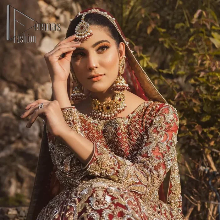 Love is in the air. A maroon blouse in maroon colour is hand-rendered in gold and is enhanced with naqshi, tilla, dabka, and kora along with the magic of zardozi. The boat shape neckline of the following blouse is pleasing to the outfit when combined with full sleeves to make your reception day more memorable. The flared lehenga in the same colours has gorgeous embroidery patterns and is paired up with a dupatta which is framed with a four-sided embellished border. It is further prominent with a sequin spray to give you the look of a model of the era.