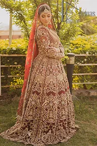 Love is in the air. A maroon blouse in maroon colour is hand-rendered in gold and is enhanced with naqshi, tilla, dabka, and kora along with the magic of zardozi. The boat shape neckline of the following blouse is pleasing to the outfit when combined with full sleeves to make your reception day more memorable. The flared lehenga in the same colours has gorgeous embroidery patterns and is paired up with a dupatta which is framed with a four-sided embellished border. It is further prominent with a sequin spray to give you the look of a model of the era.