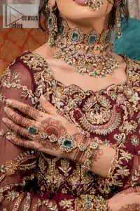 Take your style up a few notches in this elegant reception piece. A pure organza maroon fluffy lehnga is beautifully hand-rendered with golden embroidery and enhanced with tilla, sitara, pearls, dabka and zardozi work. It is paired up with a blouse choli with tilla motifs on the full sleeves along with boat shape neckline to make your Big day astonishing and remarkable. The ivory organza dupatta has a four-sided embroidery adorned with pearls and Sitara and is framed with a scalloped style.