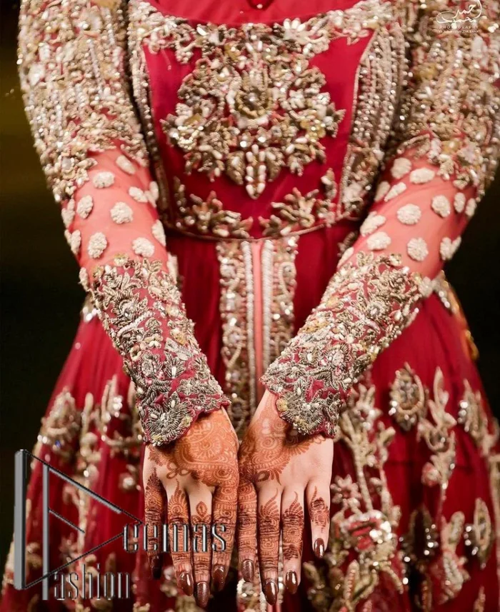 The magic of luxurious romantic silhouettes, giving out love and letting it come in. A maroon frilled maxi that is purely designed for your reception and hand-crafted with Sitara, pearls, tilla , and dabka along with the magic of zardozi. Further, it is handsomely ornamented with multiple embroideries to steal everyone's heart. The round shape neckline enhances the beauty of the outfit when comes with full sleeves to make you the star of the show. The front open style of the maxi truly makes you a unique bride of all eras.