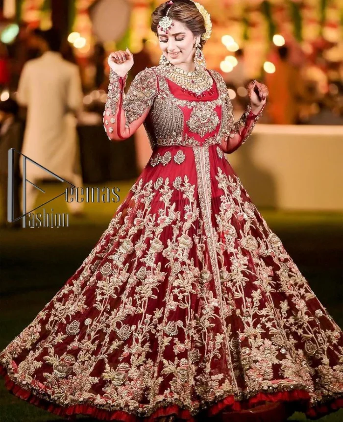 The magic of luxurious romantic silhouettes, giving out love and letting it come in. A maroon frilled maxi that is purely designed for your reception and hand-crafted with Sitara, pearls, tilla , and dabka along with the magic of zardozi. Further, it is handsomely ornamented with multiple embroideries to steal everyone's heart. The round shape neckline enhances the beauty of the outfit when comes with full sleeves to make you the star of the show. The front open style of the maxi truly makes you a unique bride of all eras.