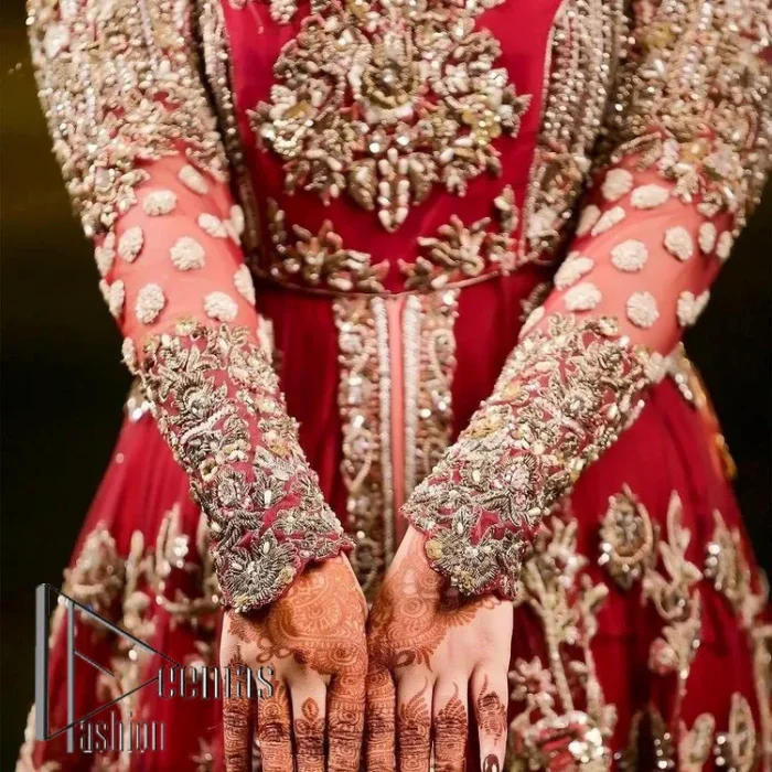 The magic of luxurious romantic silhouettes, giving out love and letting it come in. A maroon frilled maxi that is purely designed for your reception and hand-crafted with Sitara, pearls, tilla , and dabka along with the magic of zardozi. Further, it is handsomely ornamented with multiple embroideries to steal everyone's heart. The round shape neckline enhances the beauty of the outfit when comes with full sleeves to make you the star of the show. The front open style of the maxi truly makes you a unique bride of all eras.