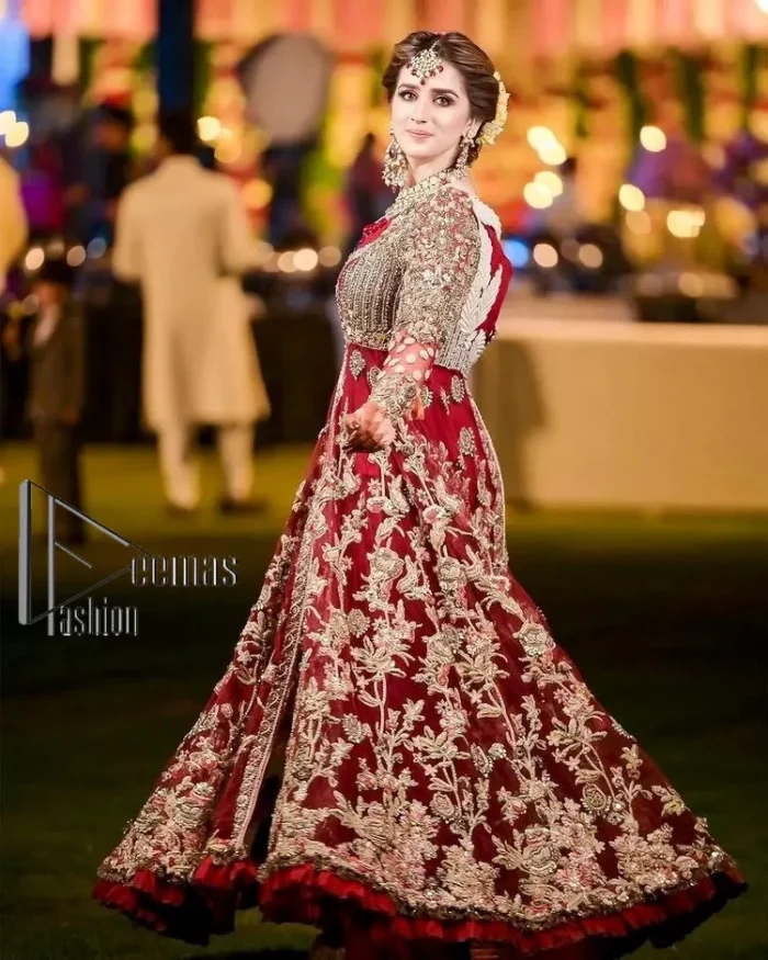 The magic of luxurious romantic silhouettes, giving out love and letting it come in. A maroon frilled maxi that is purely designed for your reception and hand-crafted with Sitara, pearls, tilla , and dabka along with the magic of zardozi. Further, it is handsomely ornamented with multiple embroideries to steal everyone's heart. The round shape neckline enhances the beauty of the outfit when comes with full sleeves to make you the star of the show. The front open style of the maxi truly makes you a unique bride of all eras.
