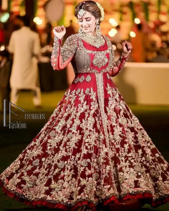 The magic of luxurious romantic silhouettes, giving out love and letting it come in. A maroon frilled maxi that is purely designed for your reception and hand-crafted with Sitara, pearls, tilla , and dabka along with the magic of zardozi. Further, it is handsomely ornamented with multiple embroideries to steal everyone's heart. The round shape neckline enhances the beauty of the outfit when comes with full sleeves to make you the star of the show. The front open style of the maxi truly makes you a unique bride of all eras.