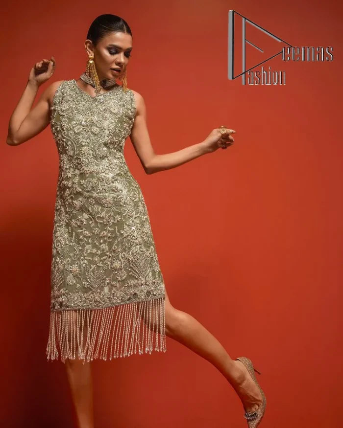 Celebrate your party events with DeemasFashion. An olive green shirt in tissue fabric, hand embellished with dabka, nakshi, cut dana, Resham, Swarovski, Mukesh, sequin and Kundan. A heavily embellished bodice featuring floral patterns all over to make your party event marvellous and shiny. The following heavy shirt is enhanced with V shape neckline along the sleeveless style. The bottom of the shirt has handsome fringes to give you a charming and splendid look.