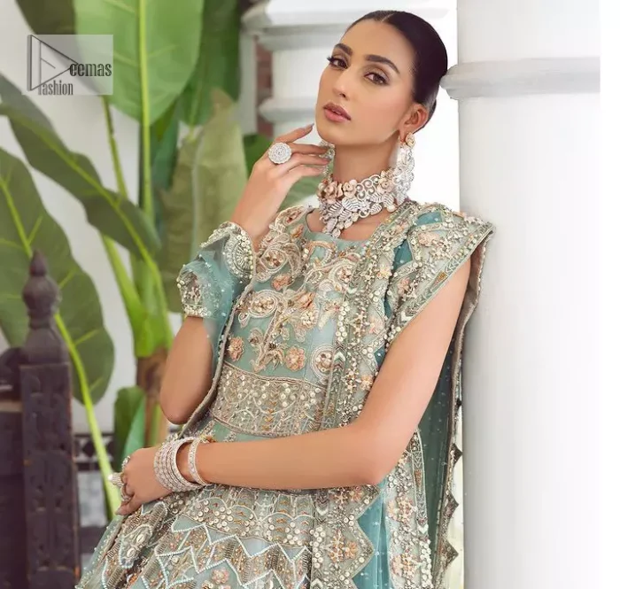 Be a fashion diva in this true modern classic Nikah outfit! The pale blue pleated maxi is handsomely adorned with multiple colour embroidery which is further enhanced with tilla, dabka, kora, Kundan and zardozi. The boat shape neckline makes a unique sense of the masterpiece when comes with sleeveless style. It is attractively organized with a dupatta in the same colour which is adorned with a four-sided border and enhanced with sequins sprayed all over to give you a modest look on your day.