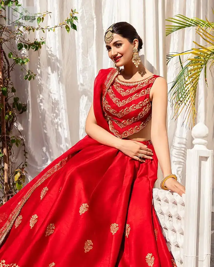Master of artists who are the secret keepers of the canvas made the perfect shade of red for you to wear at your reception. A pure organza canvas of blouse, dipped in the richest shade of red, is adorned with dabka, sequins, tilla, kora and the magic of Resham. The following blouse is further magnified with golden embroidery with the highest attention to detail. The Round shape neckline of the blouse gives so romantic look when comes with a sleeveless style. It is paired u with flared and fluffy lehenga in silk whose bottom is heavily embellished. Complete this outfit with an organza dupatta framed with four-sided borders to be the star of the show.