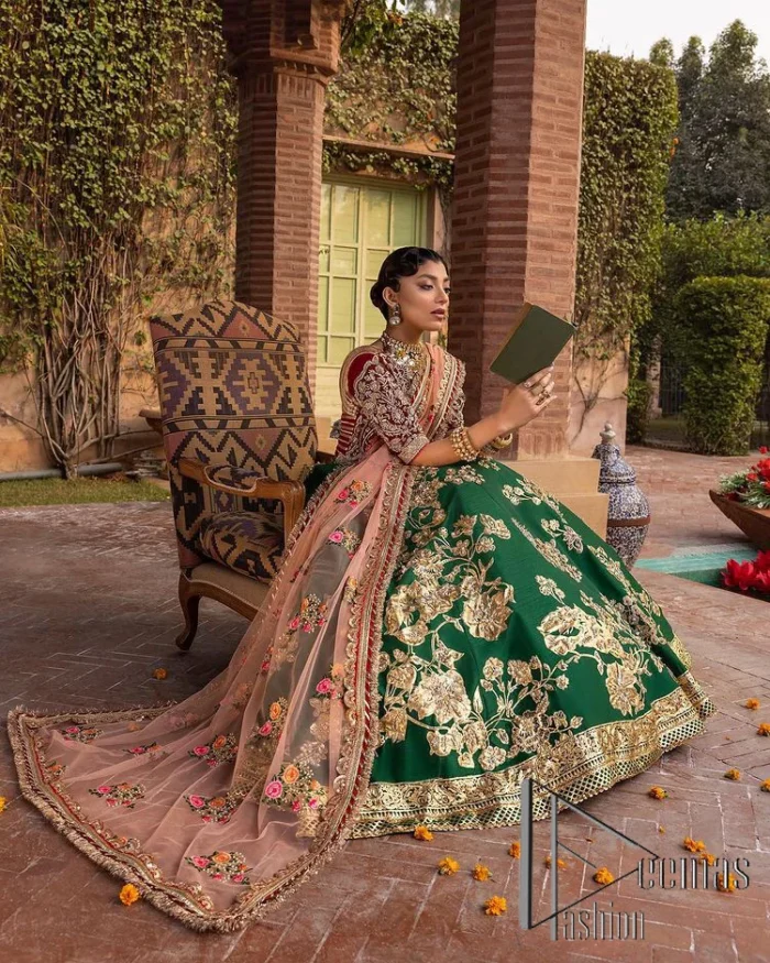 A combination of red and green are here to win hearts at your Mehndi. The attractive lehenga in green colour is hand-rendered with golden embroidery and enhanced with tilla, dabka, kora and zardozi. The floral pattern of the lehenga is followed by attractive border embroidery. It is paired up with a red blouse choli which is beautifully embellished and enhanced with V shape neckline. Further, the half sleeves style of the blouse also added beauty to this outfit. Finish this outfit with a dupatta which is ornamented with four-sided borders and floral motifs all over.