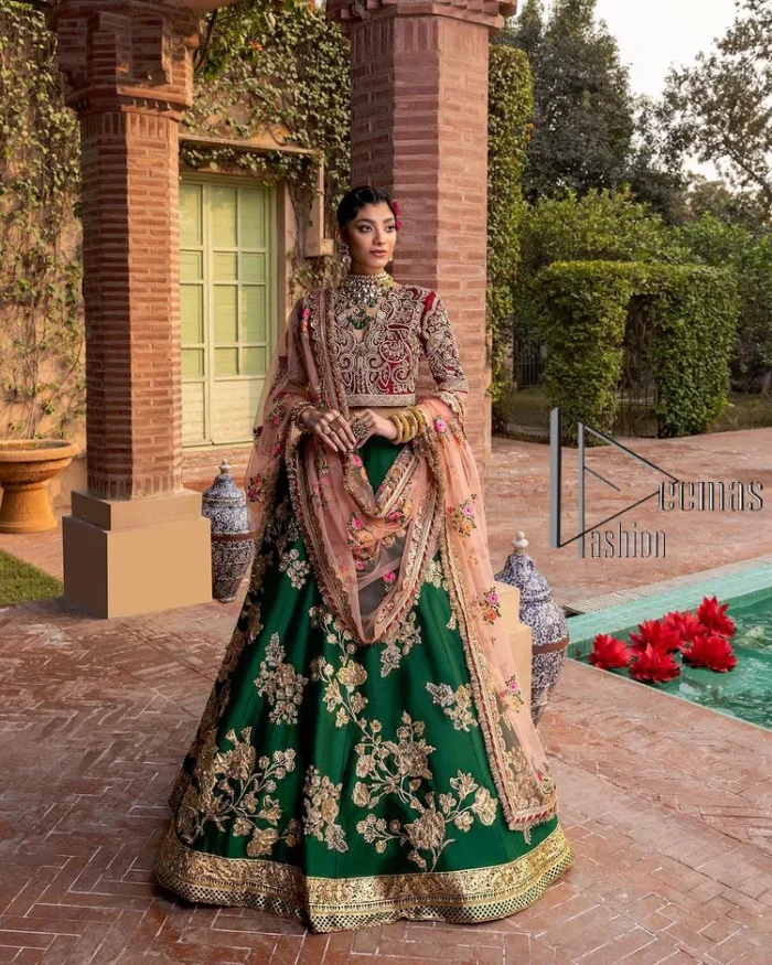 A combination of red and green are here to win hearts at your Mehndi. The attractive lehenga in green colour is hand-rendered with golden embroidery and enhanced with tilla, dabka, kora and zardozi. The floral pattern of the lehenga is followed by attractive border embroidery. It is paired up with a red blouse choli which is beautifully embellished and enhanced with V shape neckline. Further, the half sleeves style of the blouse also added beauty to this outfit. Finish this outfit with a dupatta which is ornamented with four-sided borders and floral motifs all over.