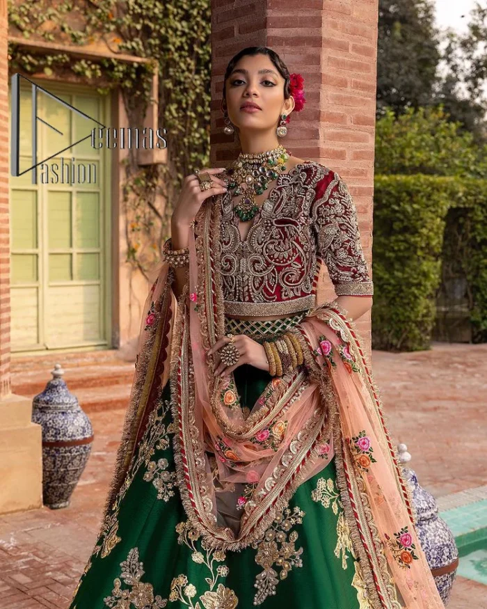A combination of red and green are here to win hearts at your Mehndi. The attractive lehenga in green colour is hand-rendered with golden embroidery and enhanced with tilla, dabka, kora and zardozi. The floral pattern of the lehenga is followed by attractive border embroidery. It is paired up with a red blouse choli which is beautifully embellished and enhanced with V shape neckline. Further, the half sleeves style of the blouse also added beauty to this outfit. Finish this outfit with a dupatta which is ornamented with four-sided borders and floral motifs all over.