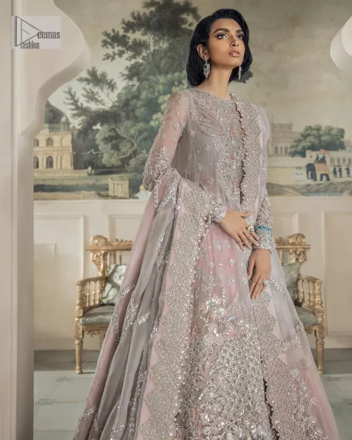 Define your true self with an outfit that speaks for its beauty. DeemasFashion introduces this rose pink maxi which is beautifully hand-crafted with silver embroidery encapsulated with tilla, dabka, kora, Kundan ad zardozi. The upper side of the maxi is adorned with tiny floral motifs to give you a sweet treat on your Walima day. Further, the high neckline along with full sleeves intensifies the beauty of the outfit. It is paired up with sharara which is best for your walima day to give you a memorable and unique look. Complete this article with a dupatta in the same colour which is adorned with a four-side border to define your self-love.