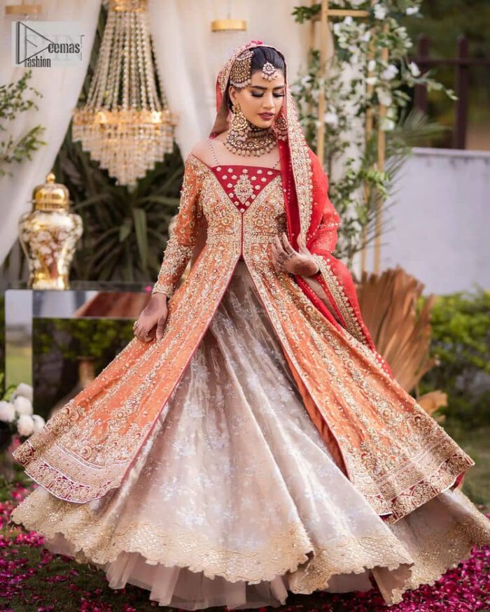 Shine bright in the sparkling ensemble from DeemasFashion. Introducing this reception outfit which begins with a rust pishwas.  This front en pishwas dipped in the richest shade of rust and is ornamented with golden embroidery which is further intensified with tilla, dabka, sequins and the real magic of zardozi. The strap neckline of the pishwas gives a unique aesthetic sense when comes with full sleeves. It is coordinated with an ivory lehenga whose border is embellished with golden embroidery. Finish this article with a dupatta framed with a four-sided embroidered border and sequin sprayed all over.