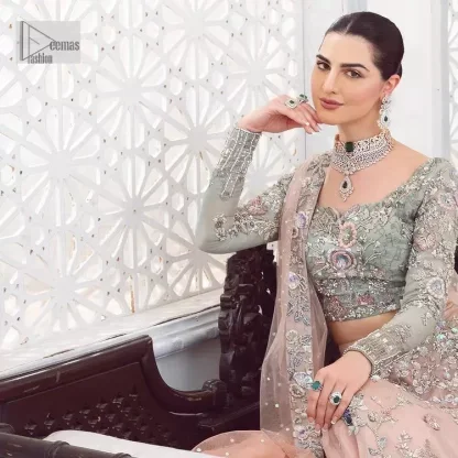 When you asked for it, we heard it. This sea green hued blouse has multiple colour embroidered details of tilla,dabka, kora, zari and sequin. It has a sweetheart neck and full sleeves style for gaining full attractiveness on your Nikah. The following blouse is organized with tea rose lehenga which is heavily embellished to make this masterpiece more aesthetic and cool.  Complete this article with a dupatta which is adorned with a four-sided embellished border. Further, it is enhanced with a sequin spray that you actually want for your big day.
