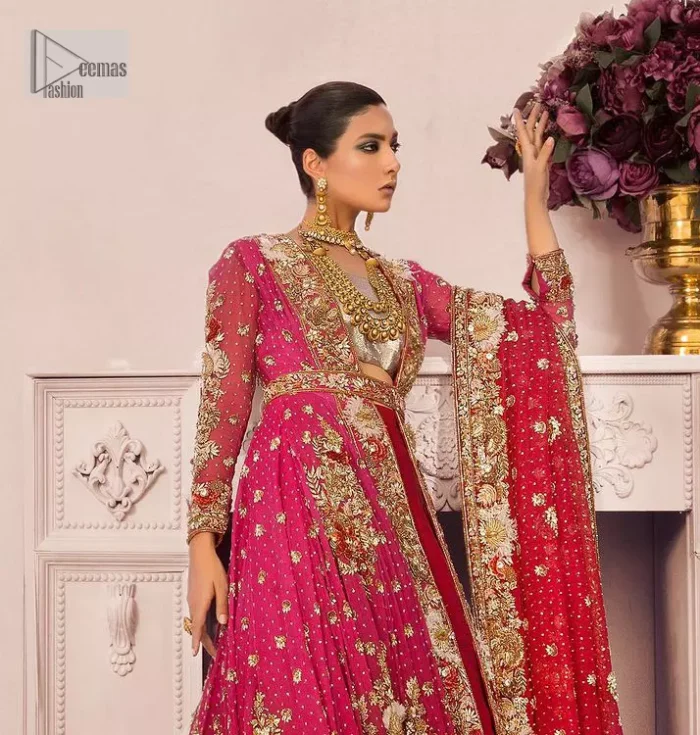 A maxi in a beautiful shade of shocking pink is deftly adorned with glowing tilla, dabka and pearls making this ensemble truly ethereal and incandescent. The following maxi is further enhanced with golden embroidery and laden with heavy floral motifs. The strapless neckline of the back train maxi also added more beauty to the outfit when comes with full sleeves. It is paired up with a plain can-can lehenga in the red colour to balance the reception fairy look of the bride. Finish this article with a dupatta which is ornamented with a four-sided embroidery and spray of tiny floral motifs and sequins all over for more romanticness and charmeness.