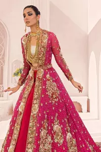A maxi in a beautiful shade of shocking pink is deftly adorned with glowing tilla, dabka and pearls making this ensemble truly ethereal and incandescent. The following maxi is further enhanced with golden embroidery and laden with heavy floral motifs. The strapless neckline of the back train maxi also added more beauty to the outfit when comes with full sleeves. It is paired up with a plain can-can lehenga in the red colour to balance the reception fairy look of the bride. Finish this article with a dupatta which is ornamented with a four-sided embroidery and spray of tiny floral motifs and sequins all over for more romanticness and charmeness.