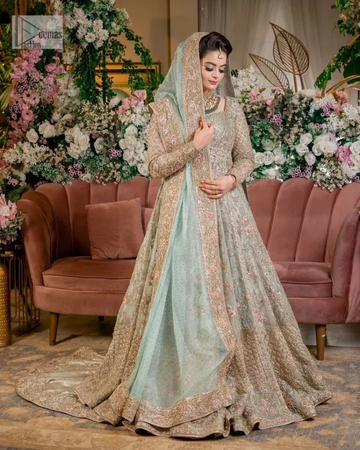 Unique embroidery designs to add some sparkle to your style on your Nikah! Light blue angrakha maxi with delicate multiple colour embroideries and intricate hand embellishments of tilla, dabka, kora, Kundan and crystals on the classic silhouette. Designed to flaunt your best features, the full sleeves carry beautiful embroidery with a square neckline. The following maxi along with the back train lehenga gives this outfit a unique look. Paired with a dreamy dupatta framed with embellished borders, this look is the epitome of ethereal and easy elegance.