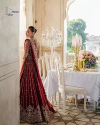 Keep it dreamy and classic with the best DeemasFashion reception wear! The handsome deep red outfit with blouse and lehenga is gracefully embellished with silver embroidery that gives you a head-turning appearance on the wedding day. The blouse is enhanced with tilla, dabka, kora, Kundan and crystals. The round neckline of the blouse makes this glamorous attire an epitome of royalty and grace. Luxury designs on half sleeves add super beauty to the outfit. It is organized with a lehenga adorned with embroidery to make your day charming. Finish this outfit with a dupatta embellished with four-sided borders and which is sprinkled with sequins all over.