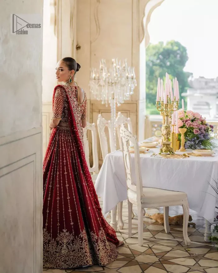 Keep it dreamy and classic with the best DeemasFashion reception wear! The handsome deep red outfit with blouse and lehenga is gracefully embellished with silver embroidery that gives you a head-turning appearance on the wedding day. The blouse is enhanced with tilla, dabka, kora, Kundan and crystals. The round neckline of the blouse makes this glamorous attire an epitome of royalty and grace. Luxury designs on half sleeves add super beauty to the outfit. It is organized with a lehenga adorned with embroidery to make your day charming. Finish this outfit with a dupatta embellished with four-sided borders and which is sprinkled with sequins all over.