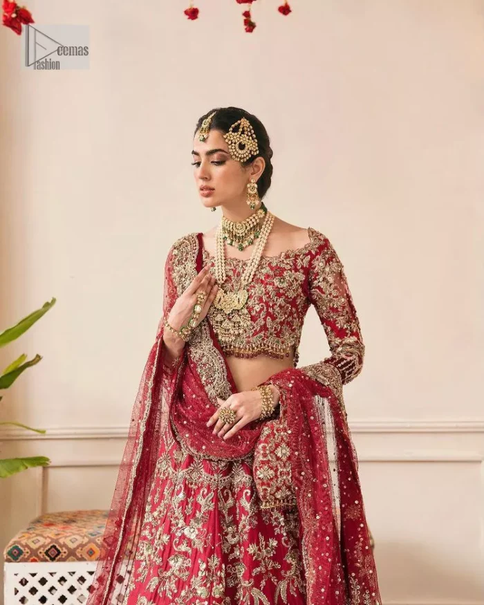 This outfit is a stand-out look for the Pakistani reception, this ensemble consists of a bright red-hued lehenga choli. This light golden embroidery is done with dense handsome work with the detailing of tilla, dabka, kora, zardozi and stone. The boat shape neckline of the following scalloped blouse intensifies the overall beauty of the outfit. Further, the beautiful floral patterns on three-quarter sleeves make this blouse super charming and ten times attractive. It is teamed up with can-can lehenga in the same colour that is ideal for the brides who want to be a queen on her Bug day. The outfit is paired with a dupatta heavily embellished all around the border, with a centre spray of sequins.