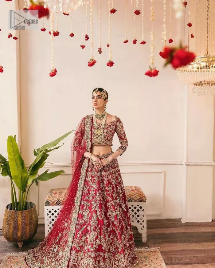 This outfit is a stand-out look for the Pakistani reception, this ensemble consists of a bright red-hued lehenga choli. This light golden embroidery is done with dense handsome work with the detailing of tilla, dabka, kora, zardozi and stone. The boat shape neckline of the following scalloped blouse intensifies the overall beauty of the outfit. Further, the beautiful floral patterns on three-quarter sleeves make this blouse super charming and ten times attractive. It is teamed up with can-can lehenga in the same colour that is ideal for the brides who want to be a queen on her Bug day. The outfit is paired with a dupatta heavily embellished all around the border, with a centre spray of sequins.
