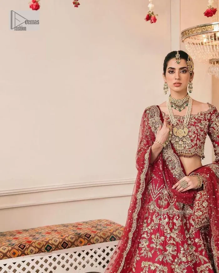 This outfit is a stand-out look for the Pakistani reception, this ensemble consists of a bright red-hued lehenga choli. This light golden embroidery is done with dense handsome work with the detailing of tilla, dabka, kora, zardozi and stone. The boat shape neckline of the following scalloped blouse intensifies the overall beauty of the outfit. Further, the beautiful floral patterns on three-quarter sleeves make this blouse super charming and ten times attractive. It is teamed up with can-can lehenga in the same colour that is ideal for the brides who want to be a queen on her Bug day. The outfit is paired with a dupatta heavily embellished all around the border, with a centre spray of sequins.