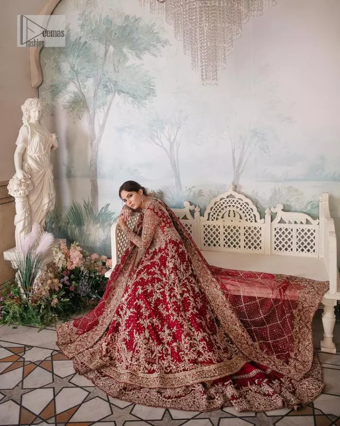 Bright and blissful! This ensemble is the epitome of grace.  The maxi is fully emblazoned with tilla, dabka, kora, Kundan and details of Zardozi. Intricate designs and fine details of golden embroidery give a perfect finishing look to the blouse. Further, embellishment full sleeves give a stunning touch to the blouse. The following blouse is further enhanced with V shape neckline. It is paired up with a lehenga that is ornamented with beautiful embroidery. The Lehenga has a huge flare and long tail. The outfit achieves the final ravishing look when paired with a delicate dupatta. The borders of this dupatta are hand-embellished and decorated with sequins sprayed.