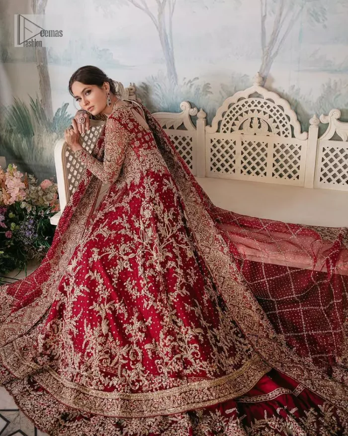Bright and blissful! This ensemble is the epitome of grace.  The maxi is fully emblazoned with tilla, dabka, kora, Kundan and details of Zardozi. Intricate designs and fine details of golden embroidery give a perfect finishing look to the blouse. Further, embellishment full sleeves give a stunning touch to the blouse. The following blouse is further enhanced with V shape neckline. It is paired up with a lehenga that is ornamented with beautiful embroidery. The Lehenga has a huge flare and long tail. The outfit achieves the final ravishing look when paired with a delicate dupatta. The borders of this dupatta are hand-embellished and decorated with sequins sprayed.